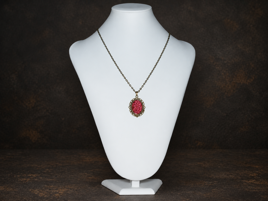 Ember Relic Filigree Pendant in antique gold with red oval centre, necklace display view.