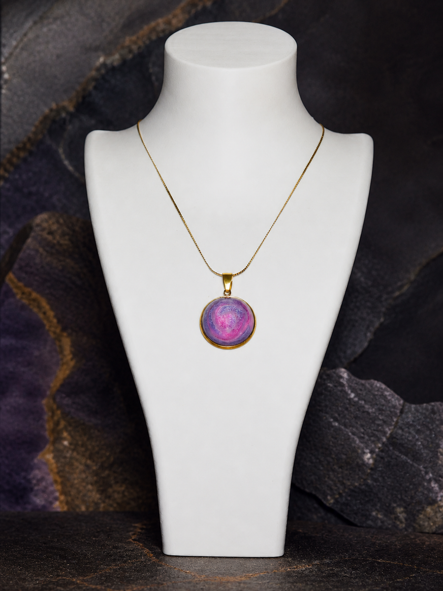 Rose Tide Orbit round 18K gold-plated pendant necklace on a white display bust against dark mineral stone