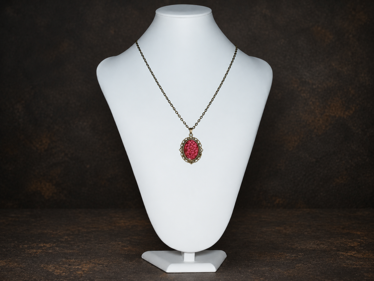 Ember Relic Filigree Pendant in antique gold with red oval centre, necklace display view.