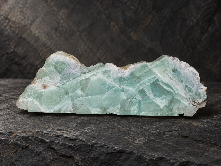 Pale seafoam-green Mexican fluorite slab on dark slate
