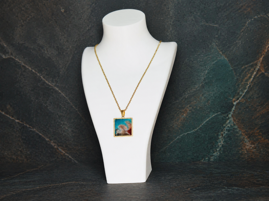 Tidal Fault square 18K gold-plated pendant on a display bust