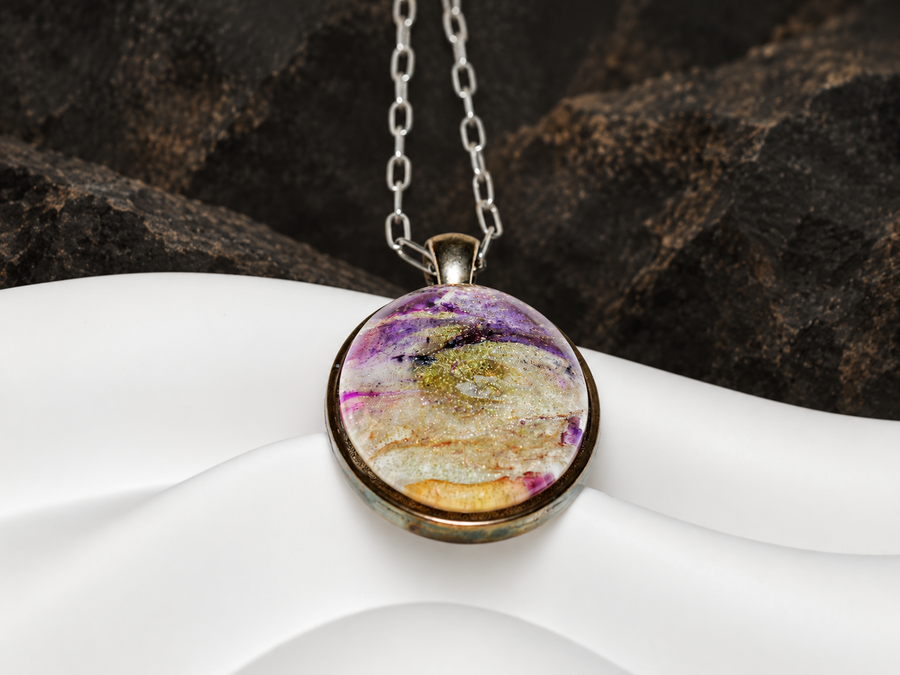 Violet Strata oval pendant close-up on a dark mineral display