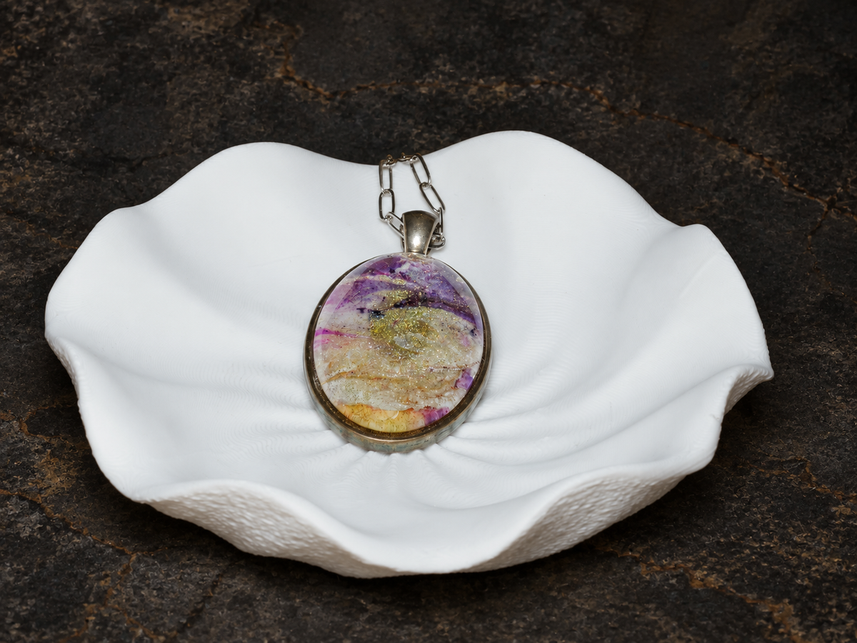 Violet Strata oval pendant displayed on a sculptural form