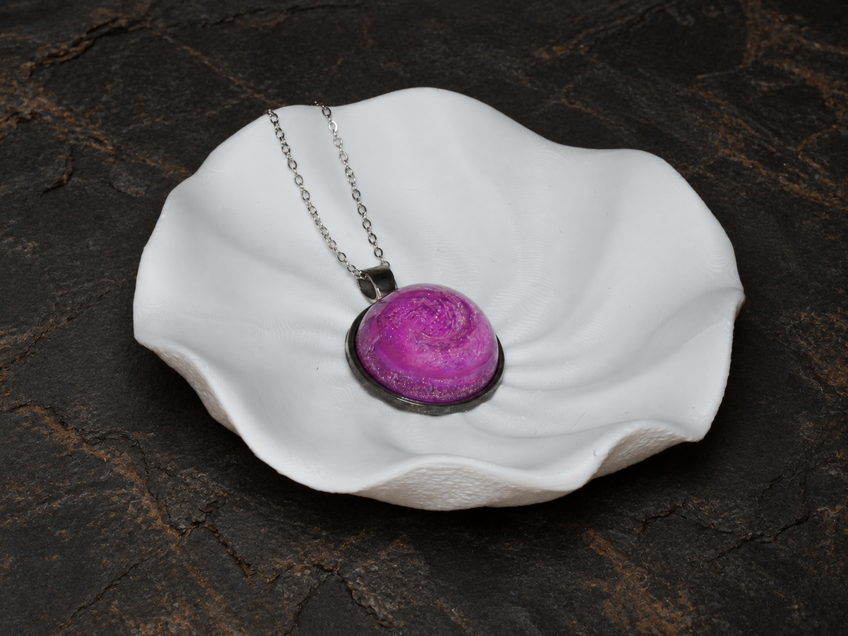 Rose Nebula round pendant on a sculptural display