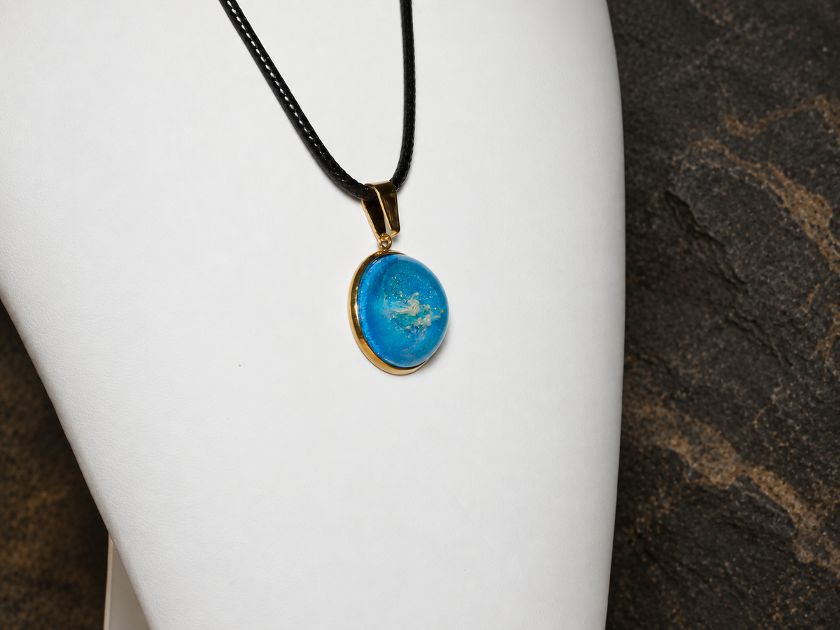 Azure Relic blue disc pendant, angled view