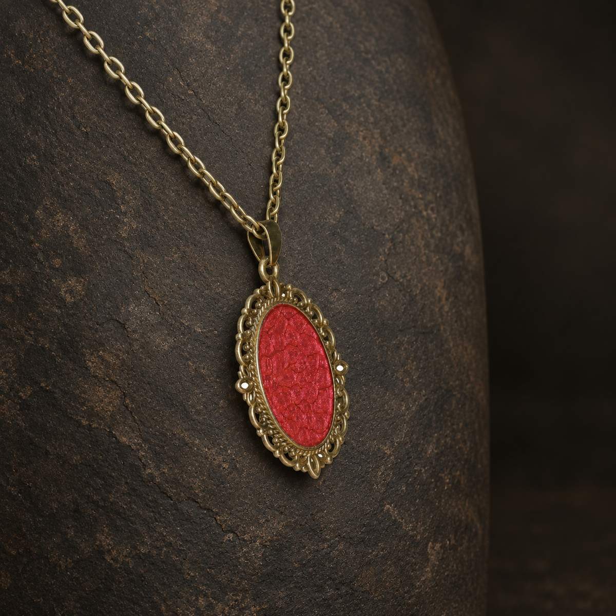 Ember Relic Filigree Pendant, angled view showing the antique gold filigree setting and matching chain.
