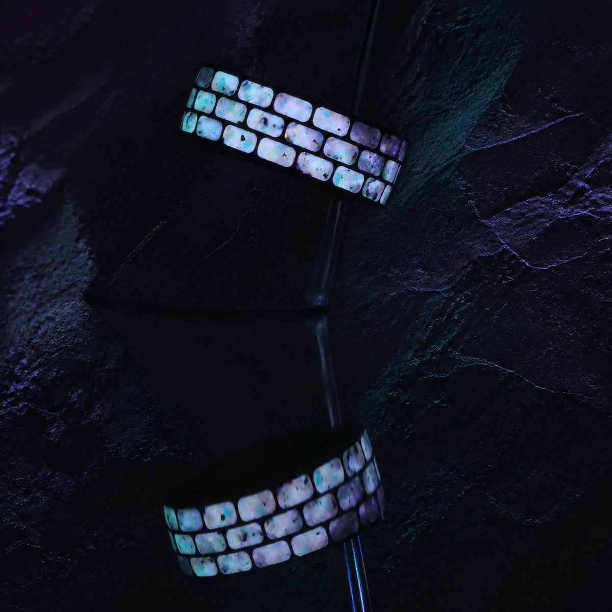 Long-exposure glow view of the Titanium Opal Glow Ring with reflection