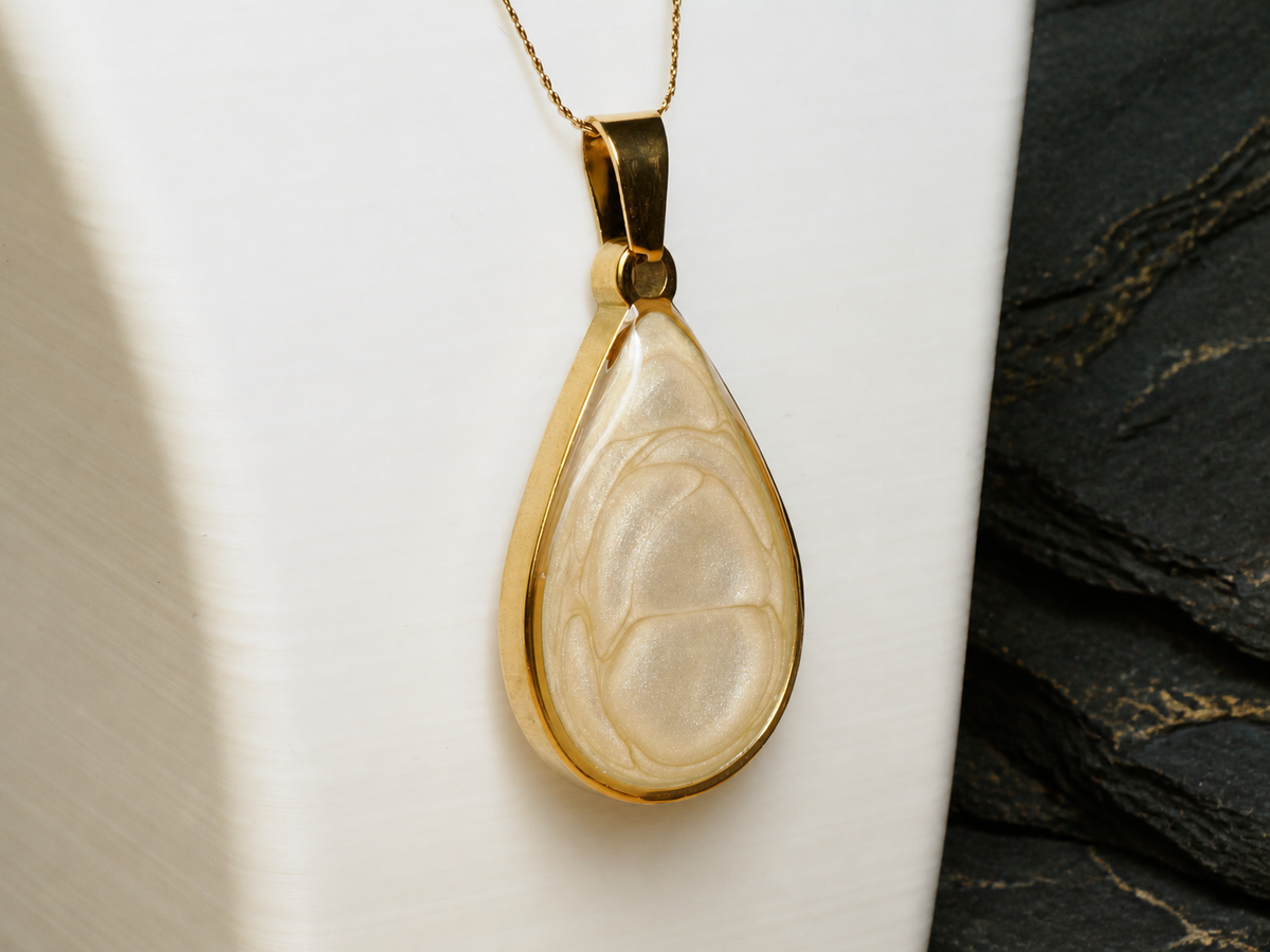 Ivory Strata teardrop pendant on a display bust at an angle
