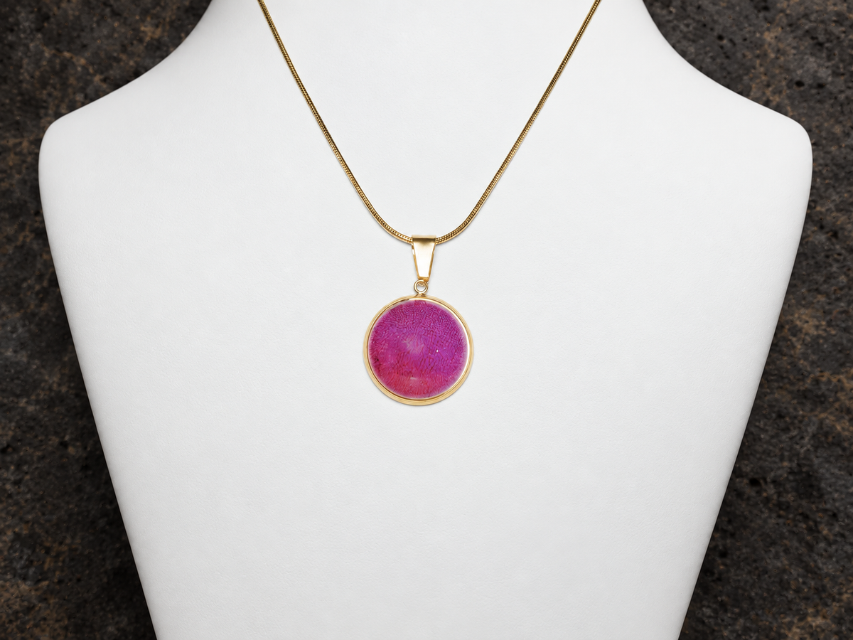 Rose Strata pink disc pendant on necklace bust, close-up