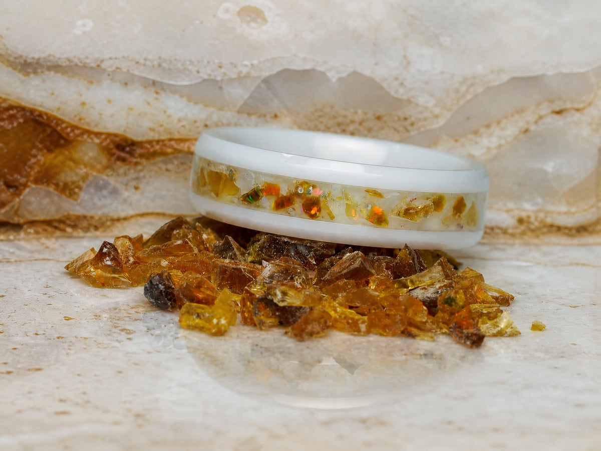 Close view of the Resin of Time: Afterglow ring on pale mineral and amber