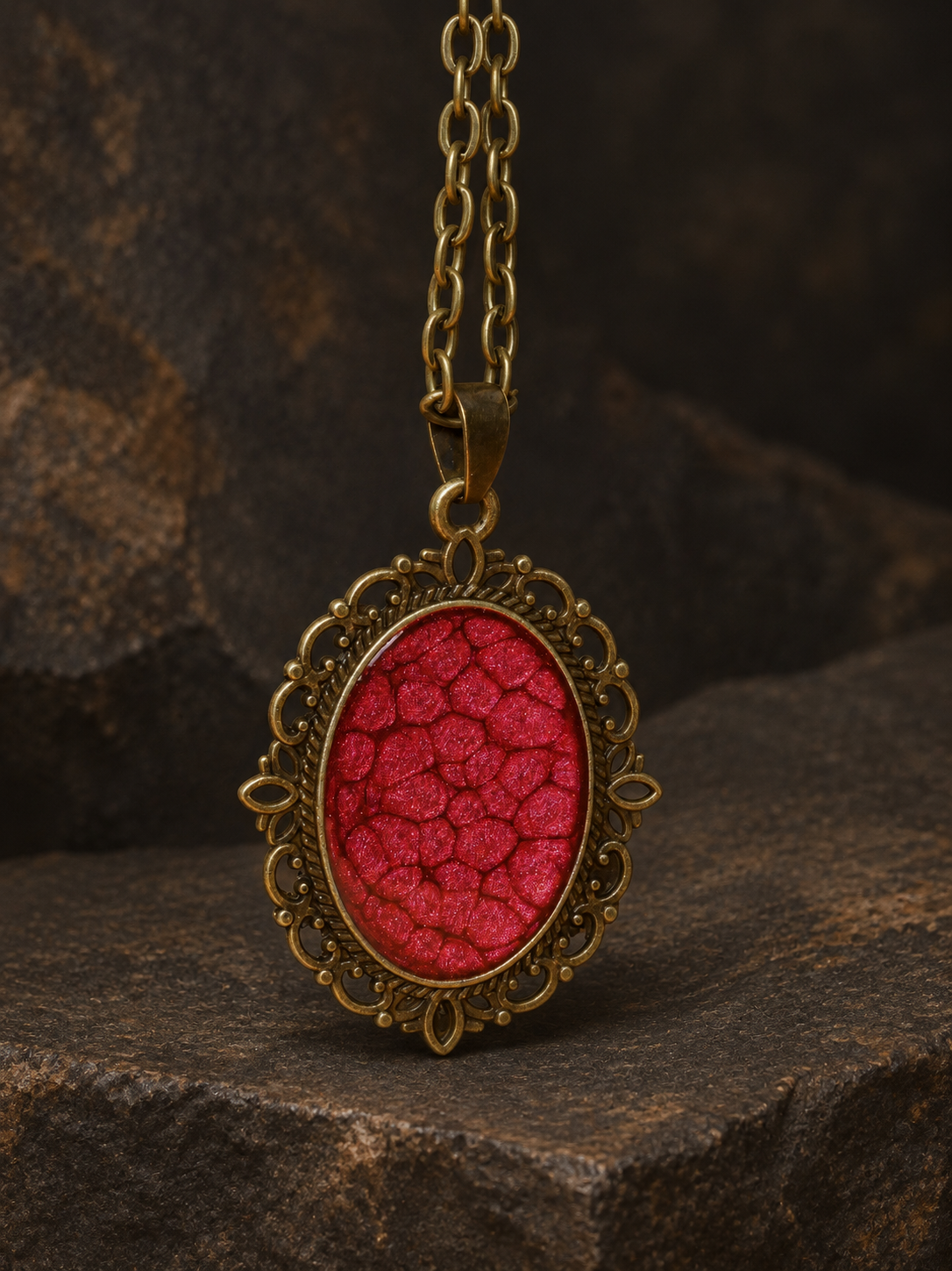 Ember Relic Filigree Pendant, close-up of the red centre, filigree border and matching chain.
