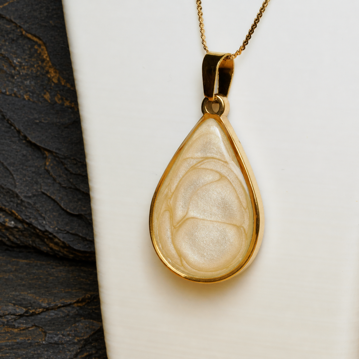 Ivory Strata gold-plated teardrop pendant detail on display bust