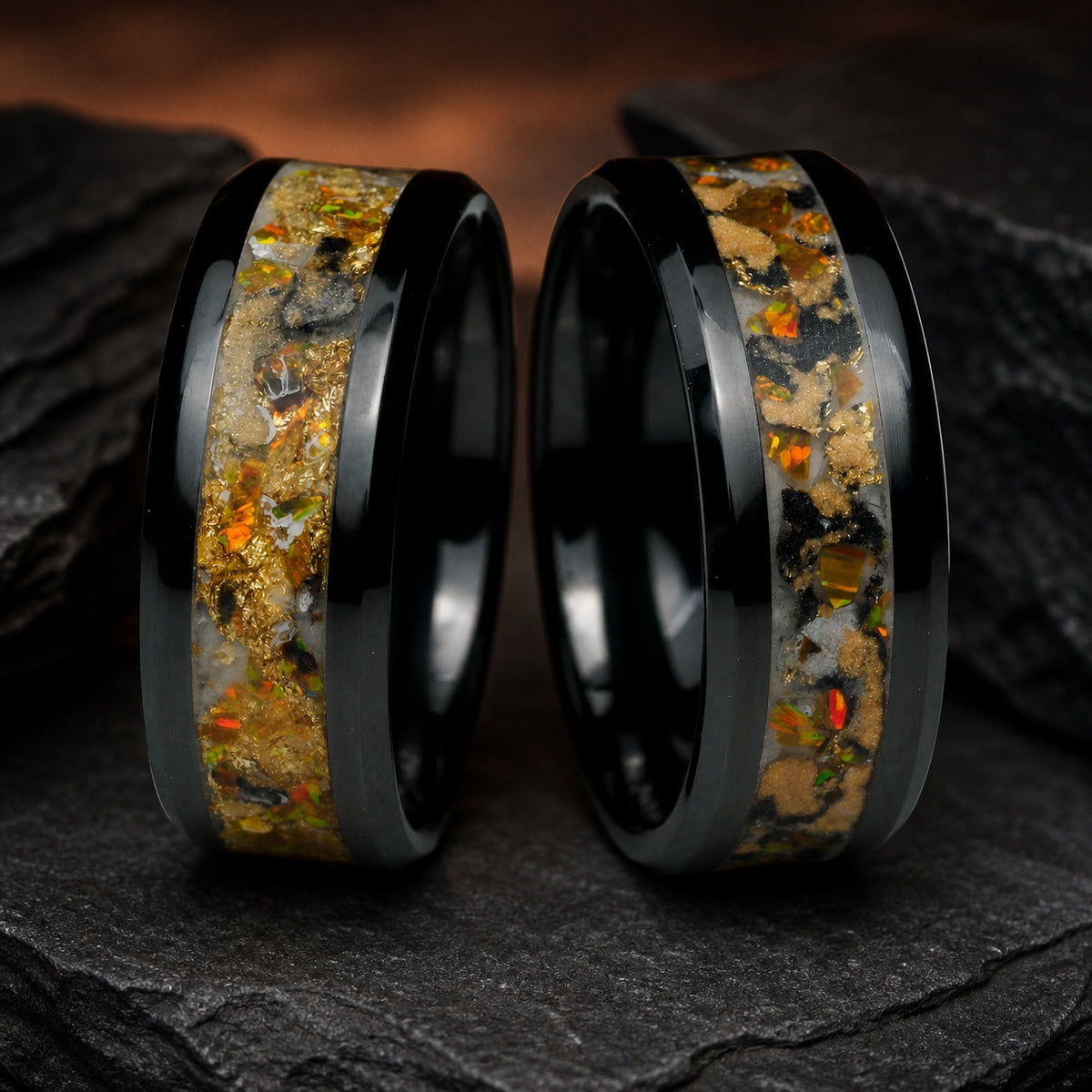 Two upright Gilded Eventide rings showing their individual inlay patterns