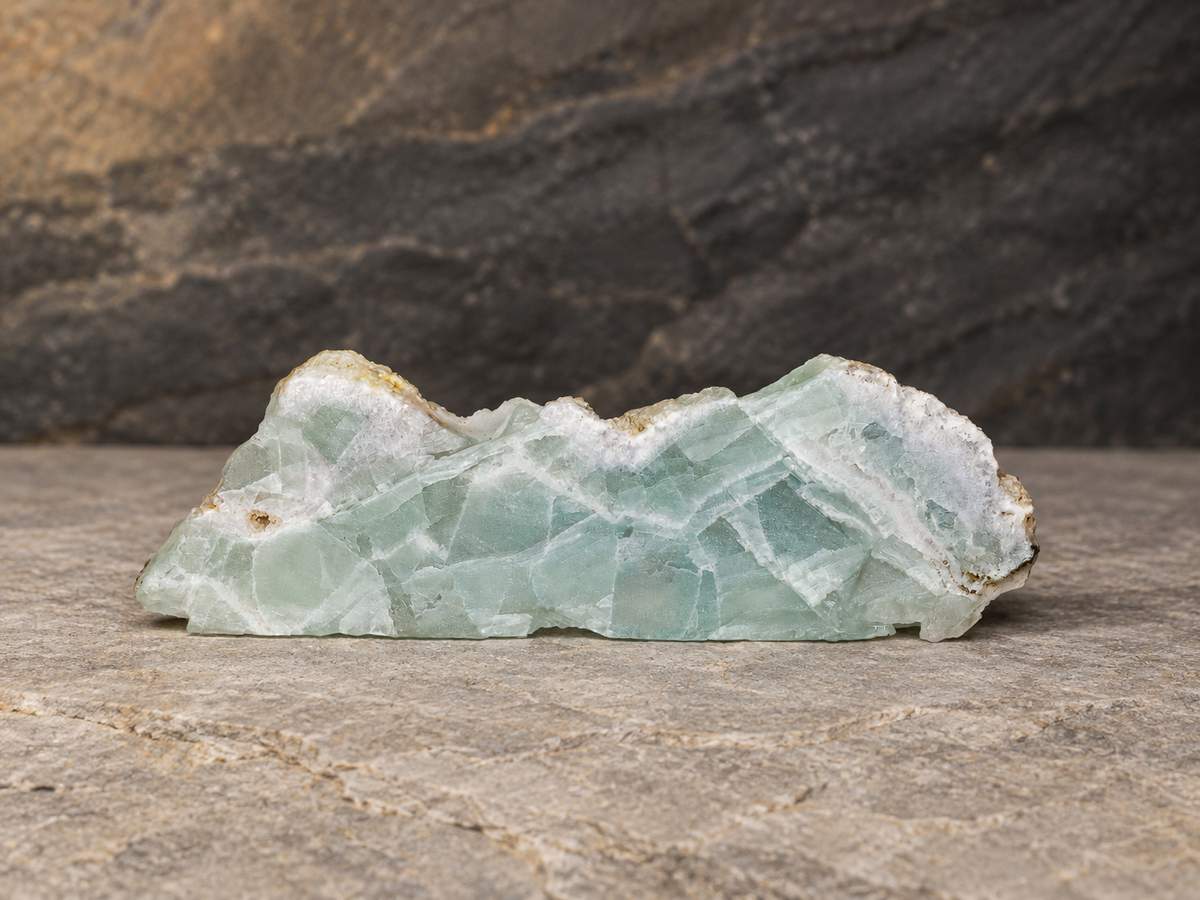 Seafoam-green fluorite slab on grey geological stone