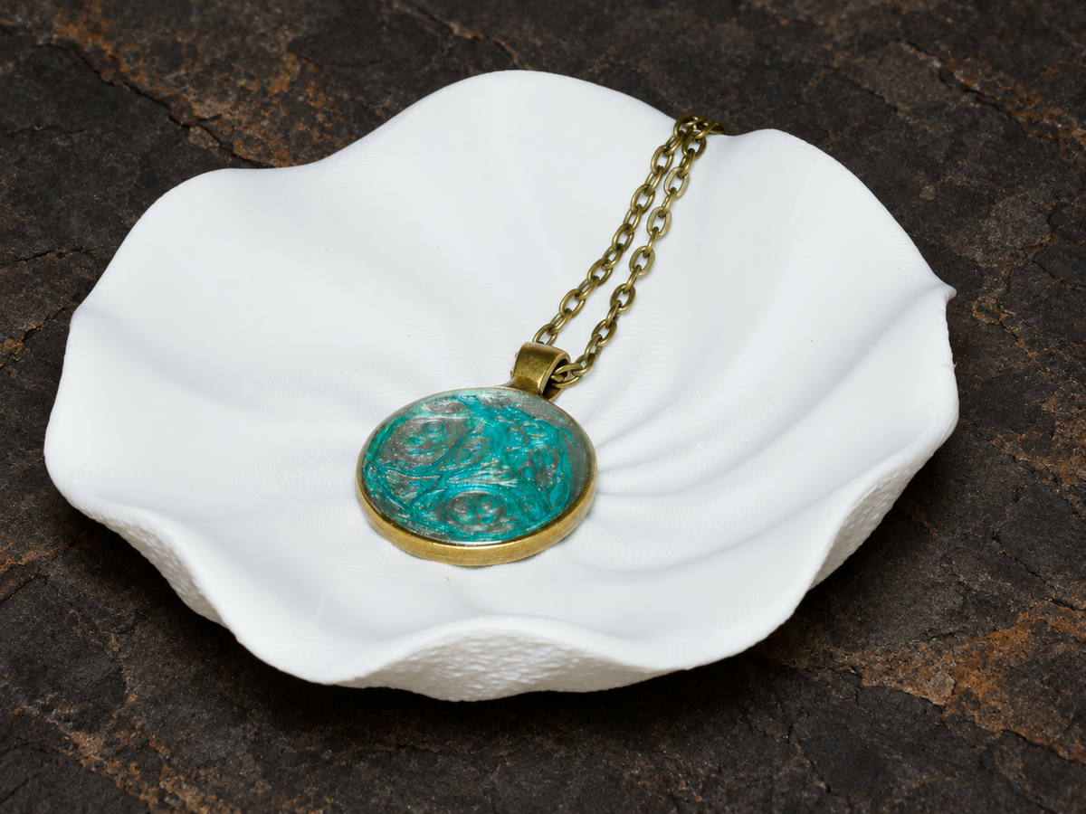 Tidal Archive round pendant angled on a sculptural display