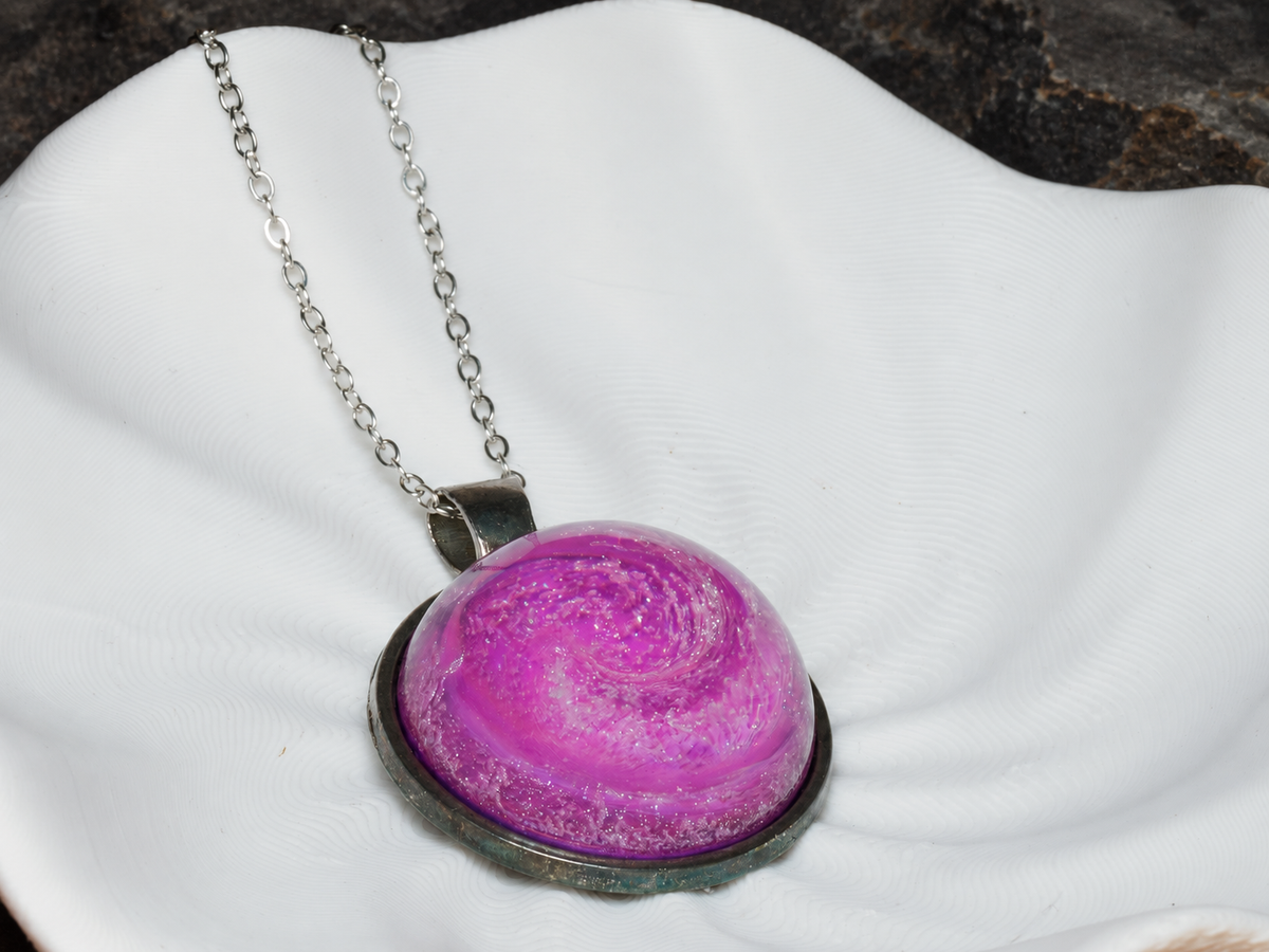 Rose Nebula pink spiral pendant close-up on sculptural display