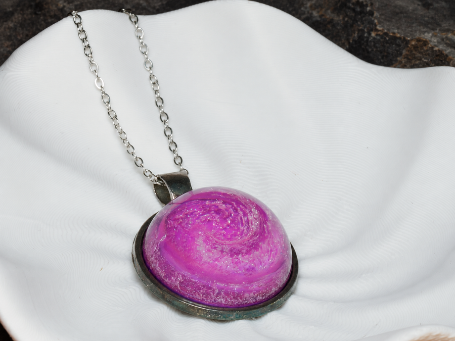 Rose Nebula pink spiral pendant close-up on sculptural display