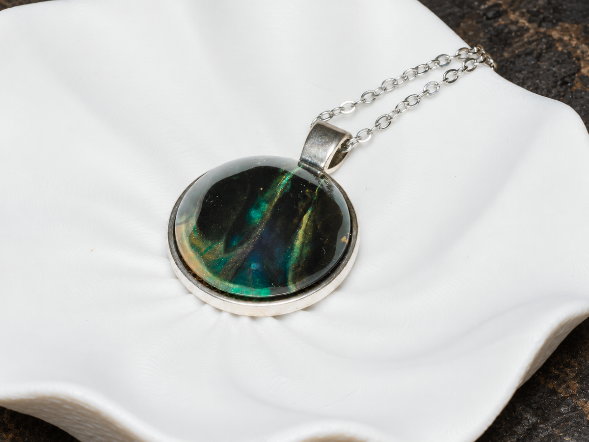 Verdant Rift round pendant close-up on sculptural display