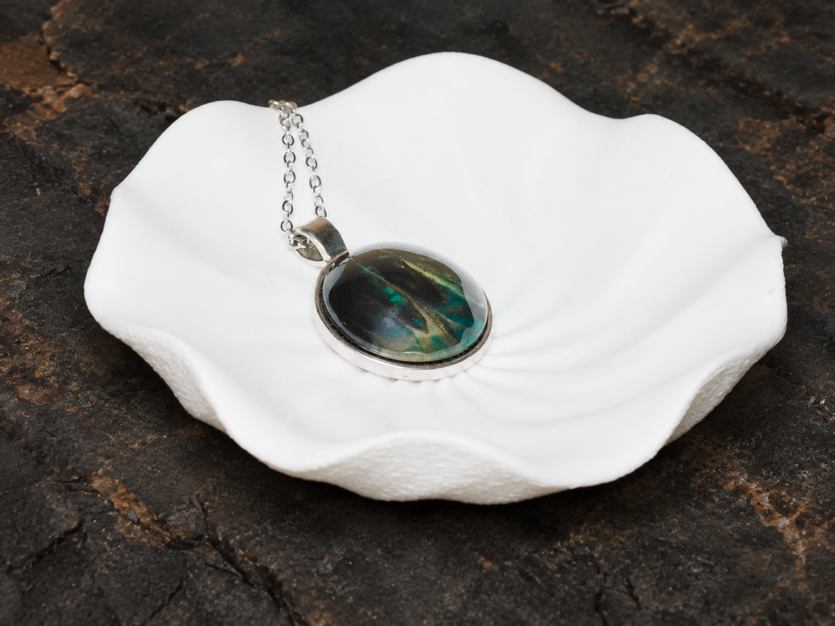 Verdant Rift round pendant on a sculptural display