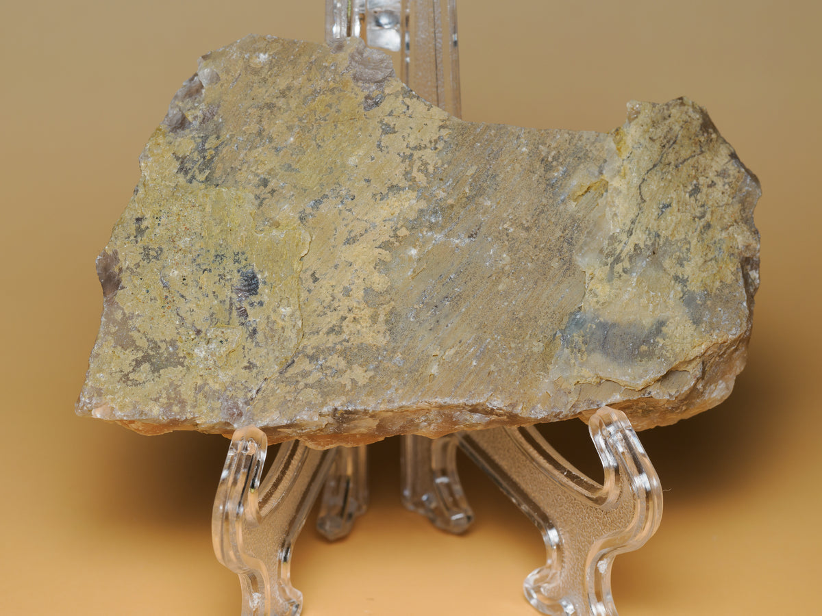 Side and reverse view of the chalcedony specimen displayed on a clear stand