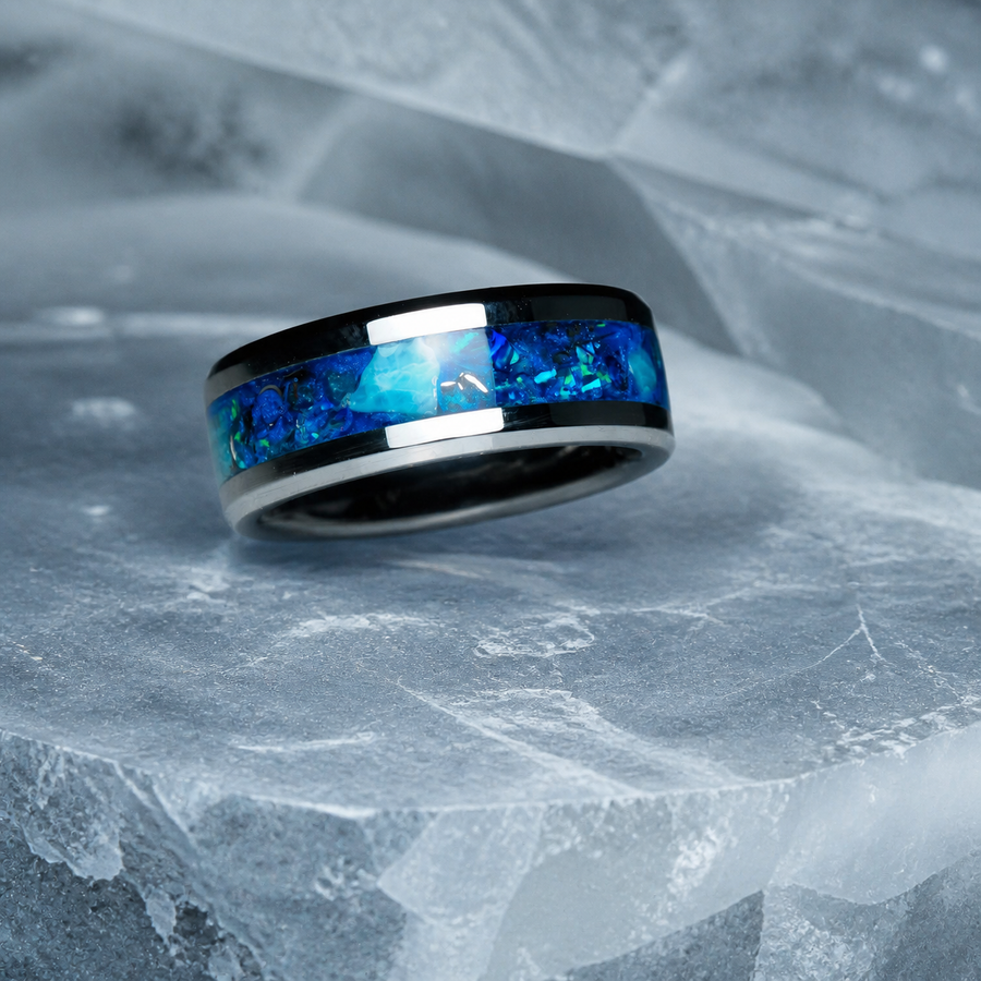 Abyssal Impact blue opal and apatite tungsten ring on pale glacier ice