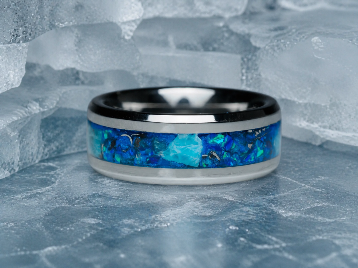 Abyssal Impact close-up showing silver tungsten band and blue meteorite inlay on ice