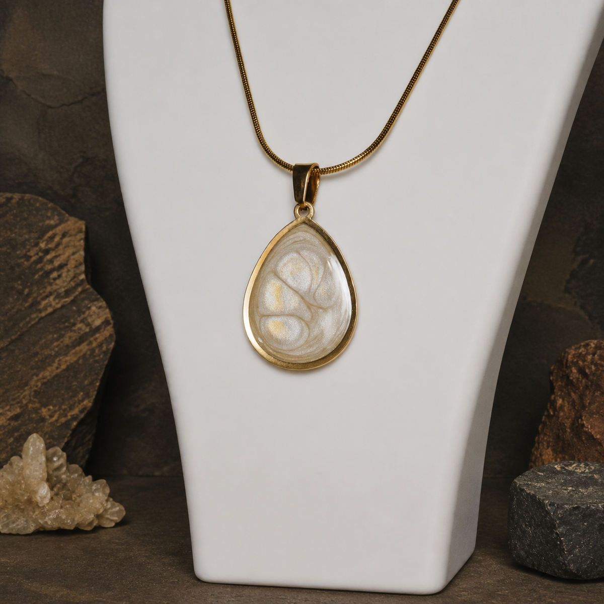 Ancient Light Pendant displayed on a white jewellery bust with rocks and crystals