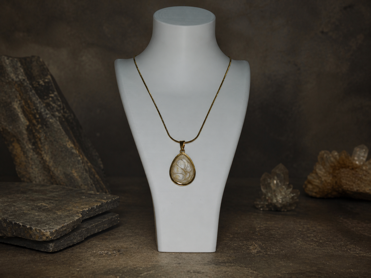 Ancient Light Pendant on a jewellery bust in a geological studio setting