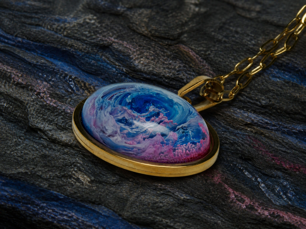 Close view of the Astral Tide pendant and gold chain