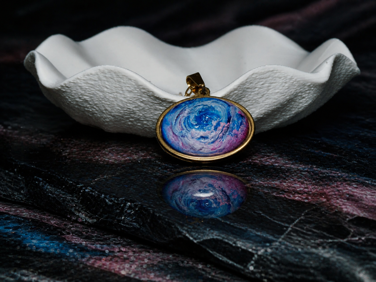 Astral Tide pendant displayed beside a sculptural white dish
