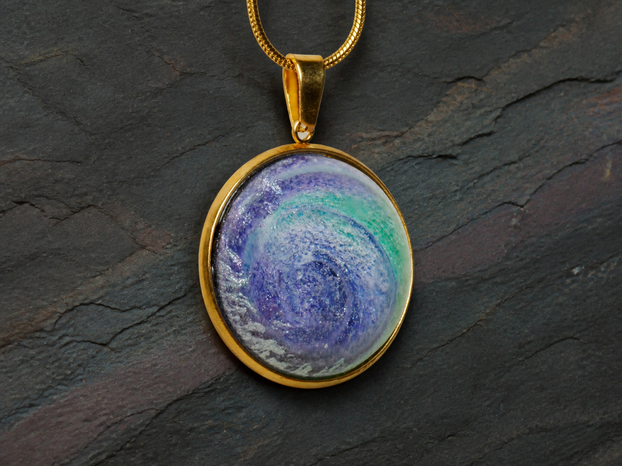 Close-up of the violet and aqua Aurora Well alcohol-ink resin pendant
