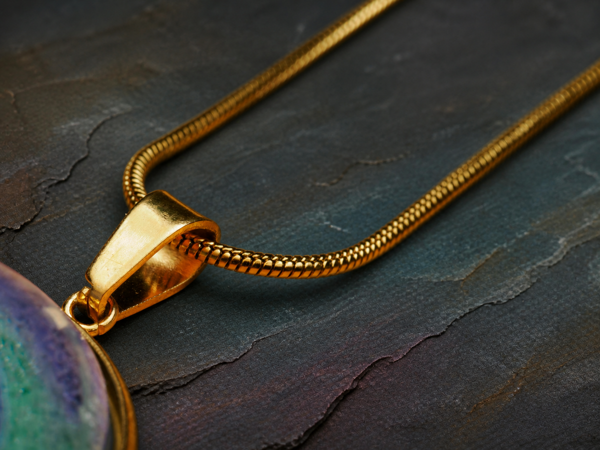 Detailed bail and 18K gold-plated stainless-steel snake chain on the Aurora Well necklace