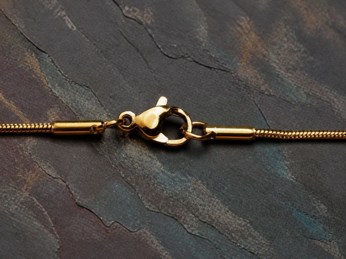 Lobster clasp and snake-chain detail for the Aurora Well gold necklace