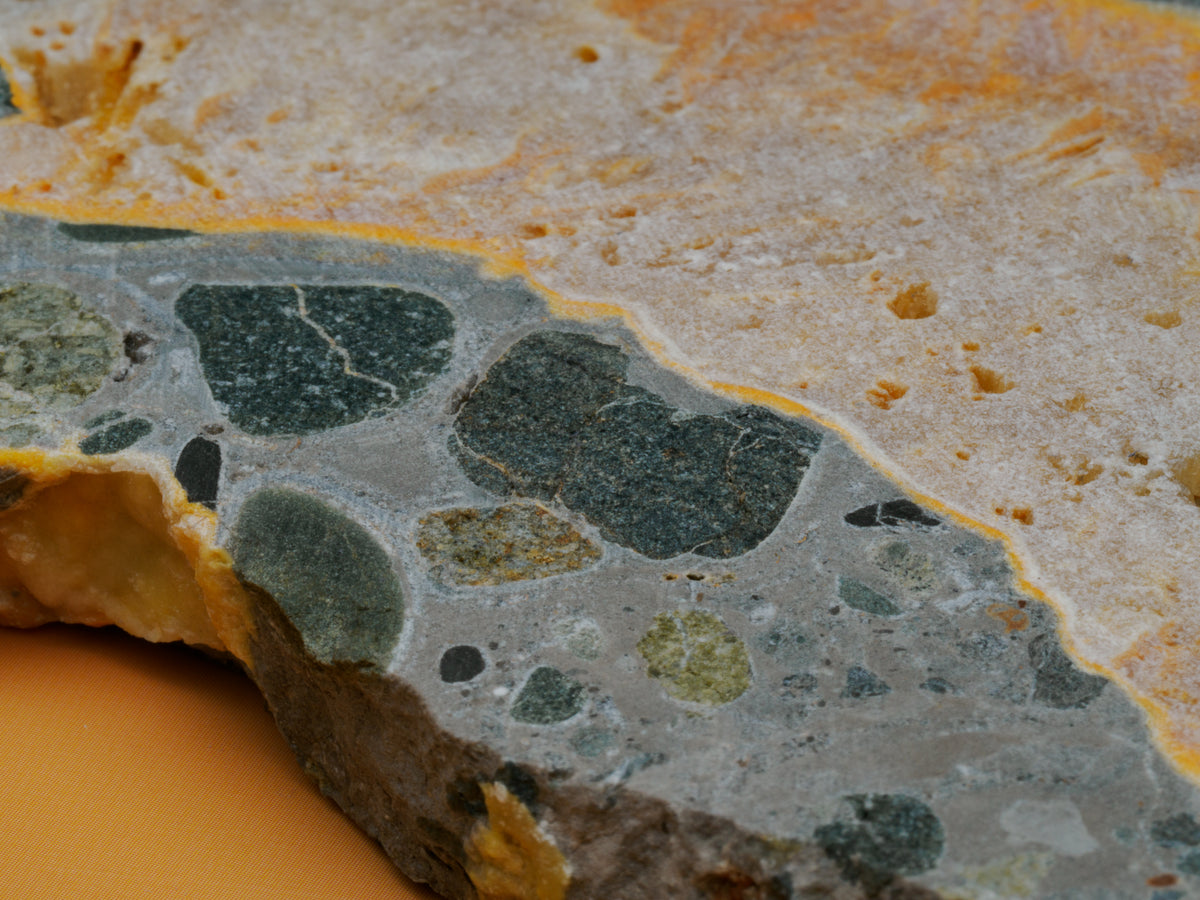 Close view of the bumblebee jasper slab's dark grey matrix and natural inclusions