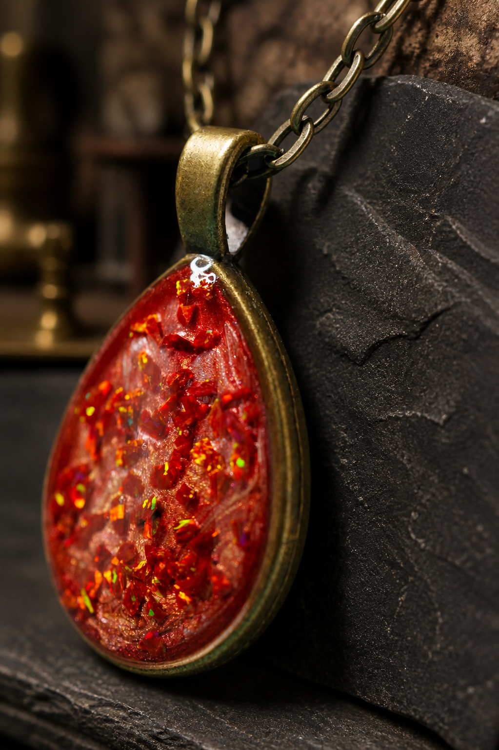 Angled detail of the Cinderstrata pendant showing its antique bronze bezel and layered depth
