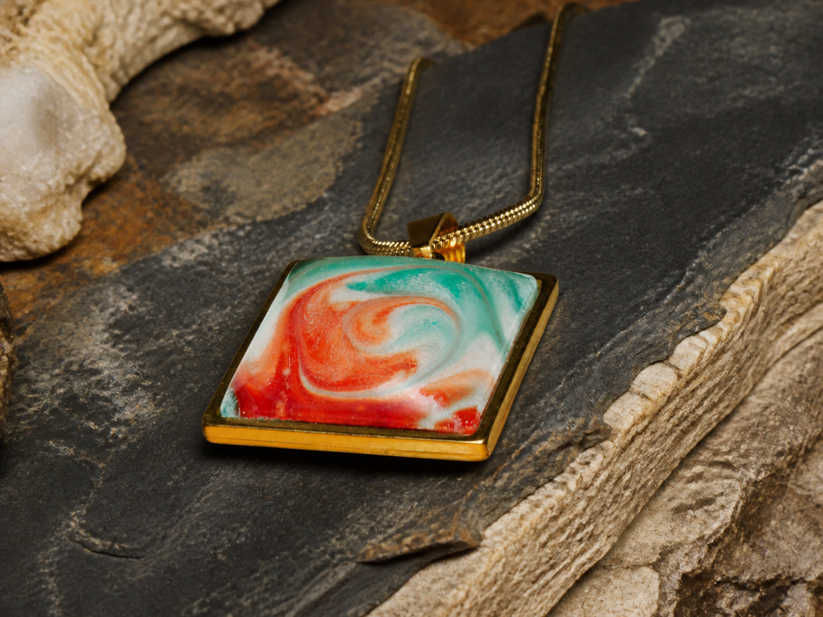 Square gold-plated pendant with domed resin artwork on slate and limestone