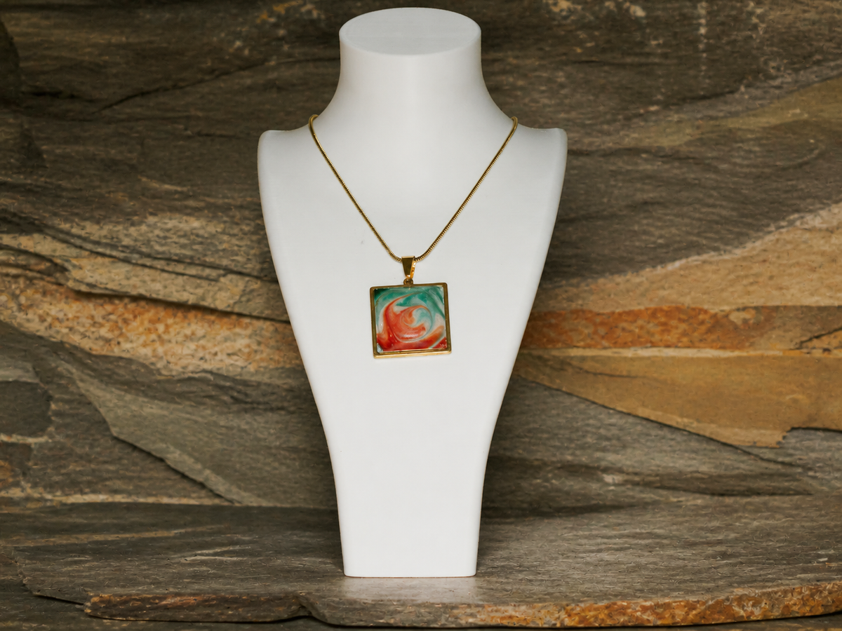 Square pendant and 45cm gold-plated chain displayed on a necklace bust against mineral rock