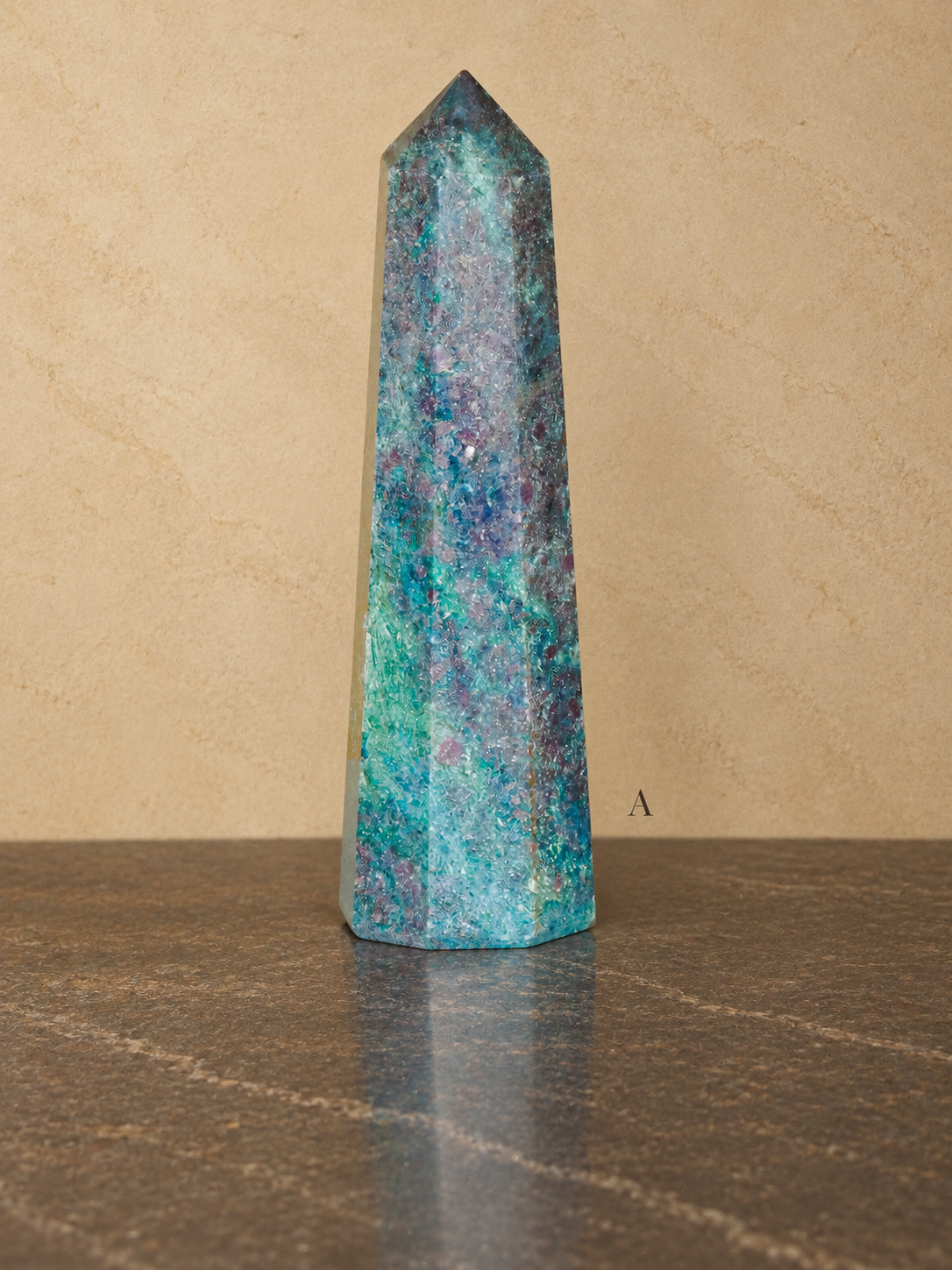 Ruby in kyanite obelisk A, 10.5 cm tall, labelled A against a neutral parchment gallery background