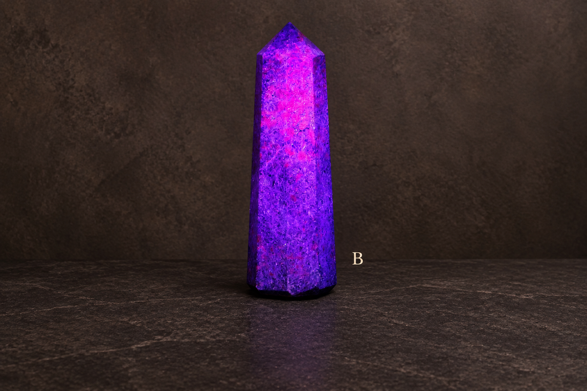 B UV-lit ruby in kyanite obelisk labelled B against a basalt gallery background