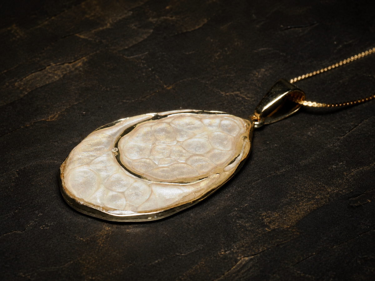 Close detail of the Earthlight Strata hand-painted pendant on a gold chain