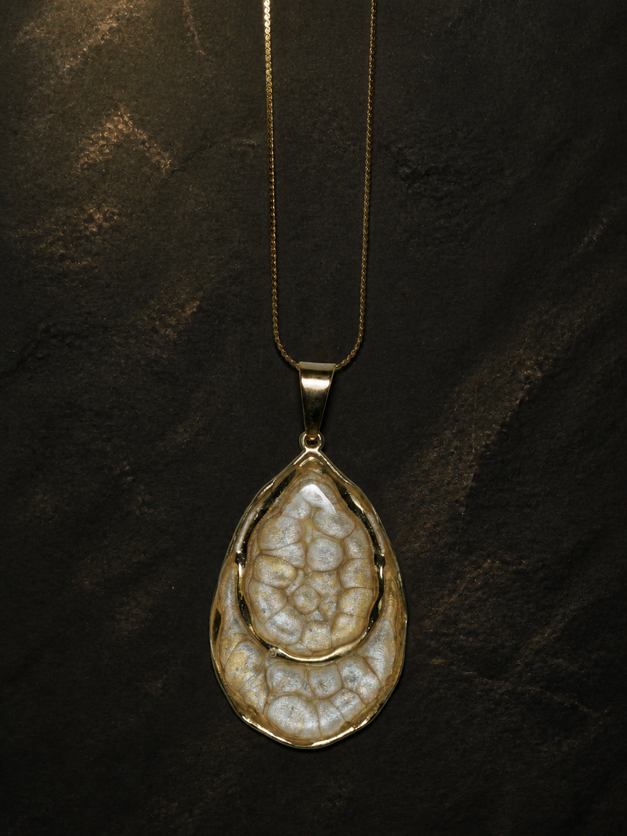 Front view of the Earthlight Strata teardrop pendant on a gold chain