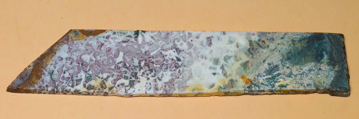Full length view of the multicolour jasper slab laid flat, with mauve, white, green and ochre patterning