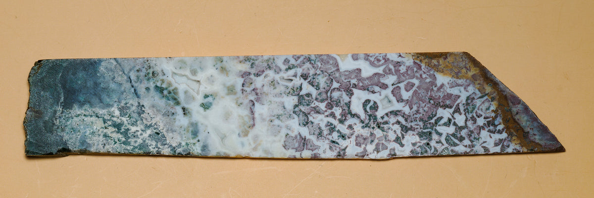 Other face of the multicolour jasper slab laid flat, showing contrasting green and mauve areas