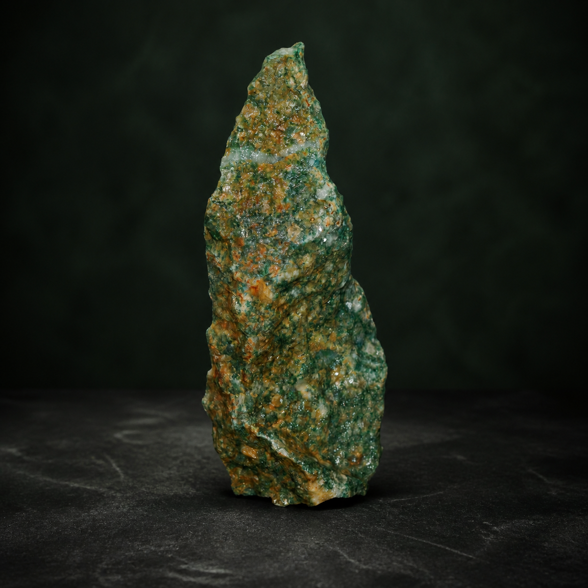 Side view of a green aventurine quartzite specimen with warm brown weathering