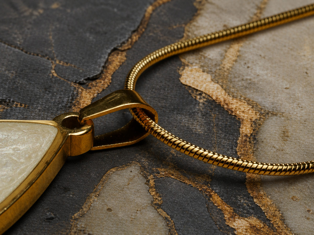 Gold-plated bail and snake chain with partial teardrop pendant on mineral stone