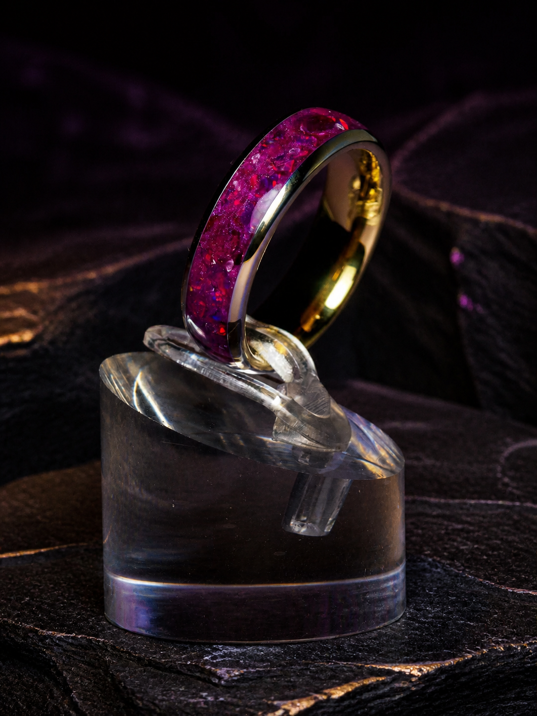 Imperial Nocturne ring on layered black stone with warm gold highlights