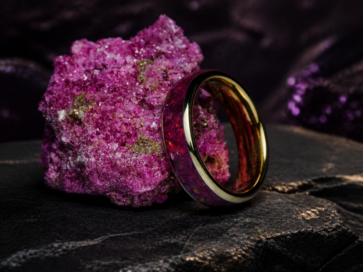 Imperial Nocturne angled gold-coated tungsten ring on dark volcanic stone