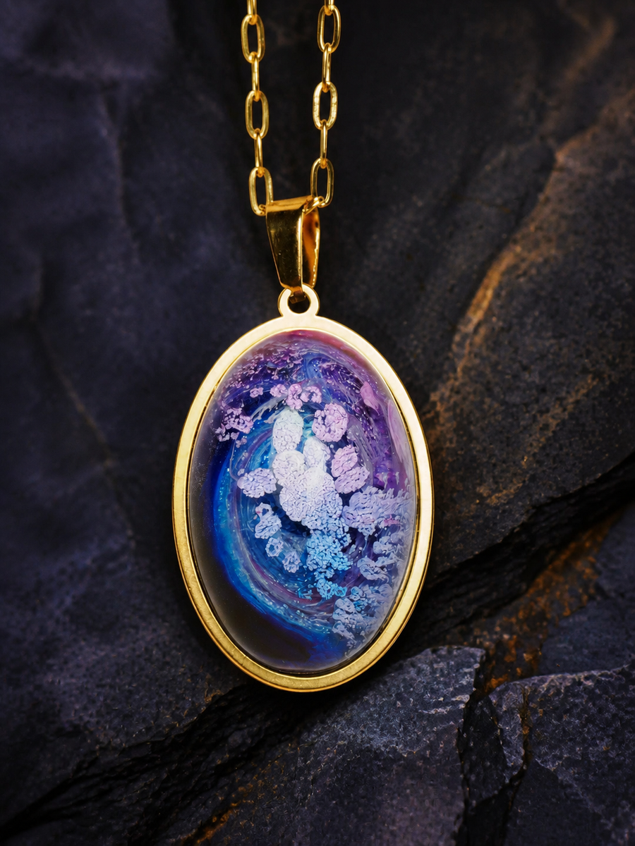 Lavender Reef oval 18K gold-plated pendant with blue and lavender resin artwork on dark mineral stone