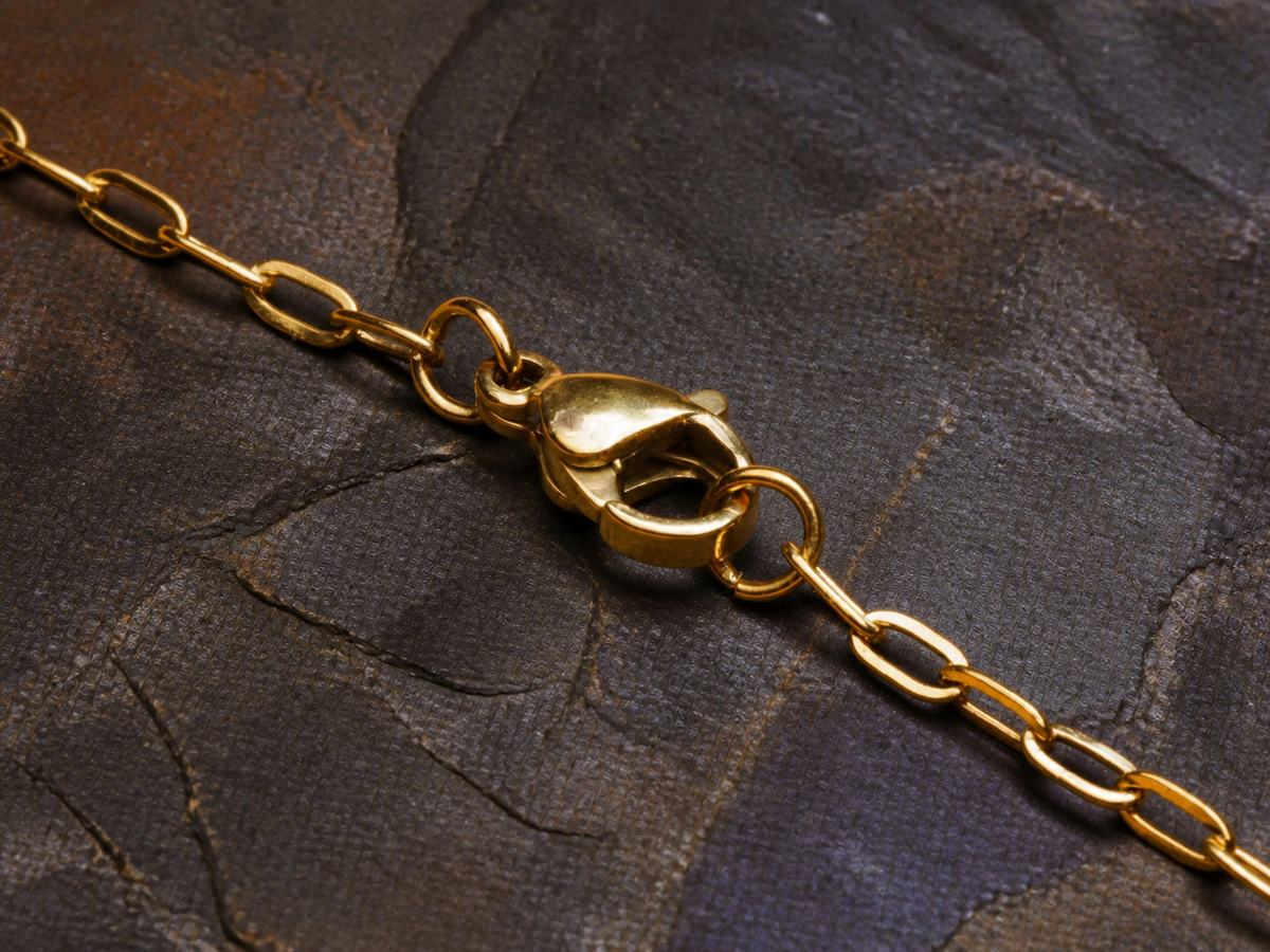 Gold chain clasp and links for the Lavender Reef oval pendant on dark mineral stone