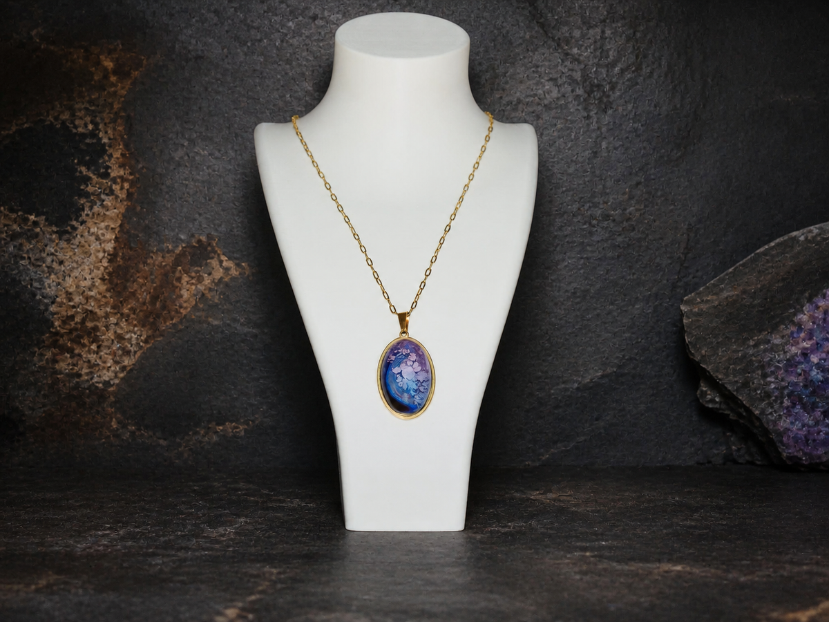 Lavender Reef oval 18K gold-plated pendant necklace on a display bust against dark stone